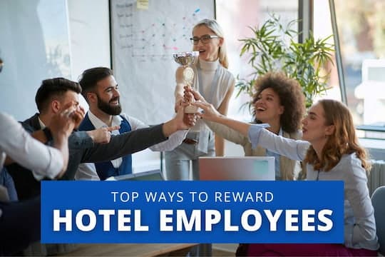 Top Ways to Reward Hotel Employees - Team holding a trophy